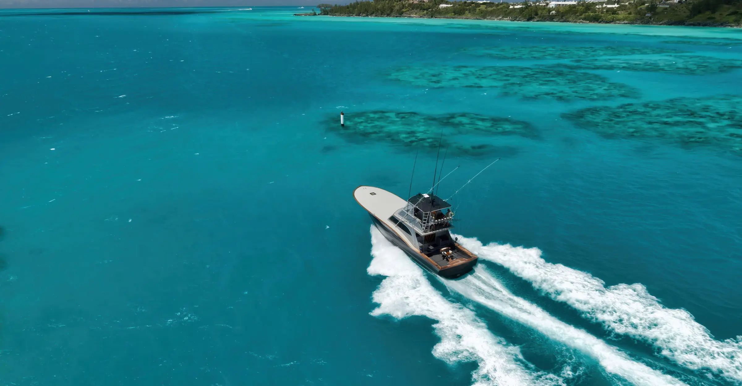 Sportfishing boat running across tropical blue water in Bermuda